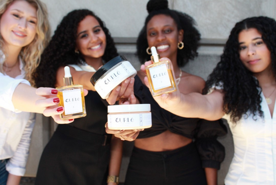 4 women holding curl care products