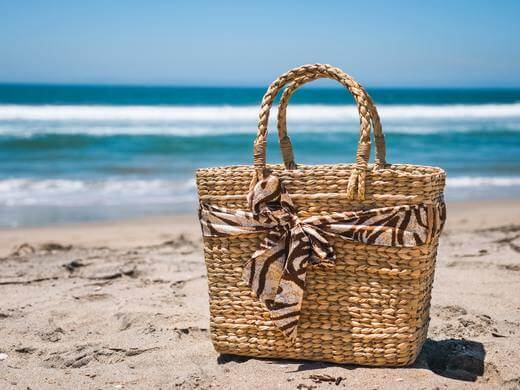 straw basket on sand on beach; summer; summertime